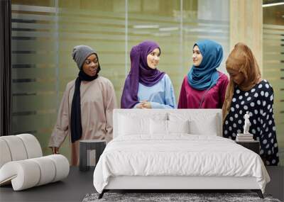 A group of four young islamic multiethnic girls chatting and walking together outdoor Wall mural