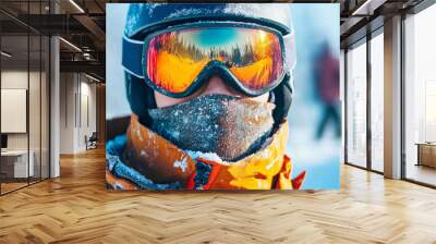 A person wearing a ski helmet and goggles is standing in the snow Wall mural