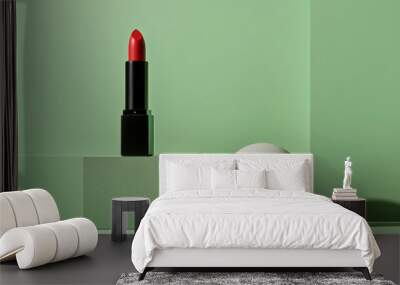 A red lipstick is placed on a green surface next to a white egg Wall mural