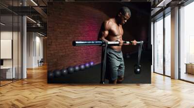 African man lifting a bar with weights in gym. Active People Sport Workout Concept Wall mural