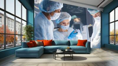 Attentive medical workers operating their patient. A surgery like this requires an anesthesiologist, a general surgeon to remove tumor and, at least two surgical nurses. Wall mural