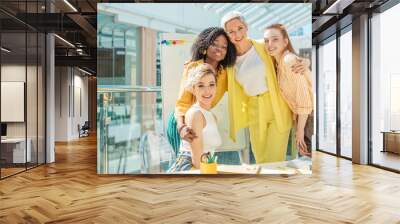 awesome successful women hugging each other nad posing to the camera, friendship, partnership. close up photo. Wall mural