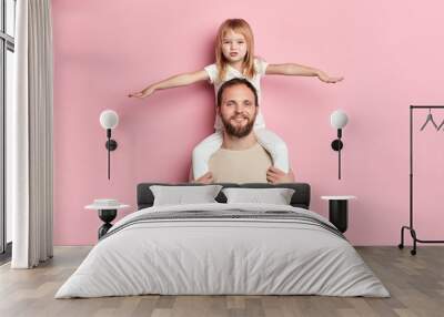 blonde beautiful girl with outstretched arms having a rest on her father s shoulder, girl playing a plane with a dad,interest, pastime Wall mural