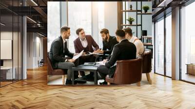 brainstorming time of business team in office, young men gathered together in office for discussing and sharing business ideas, planning strategy in modern boardroom, everyone in formal wear Wall mural