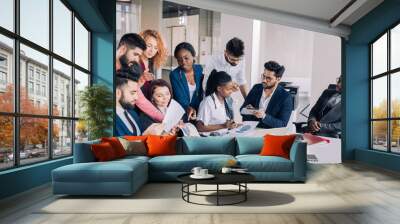 Business Corporate Management Planning Team Concept. Teamwork process.Young multiracial entrepreneurs work with new startup project in office. Nine diverse people sharing the ideas lively. Wall mural