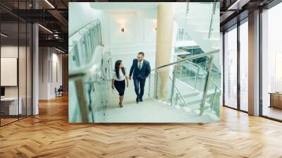 business people climbing a stair in a building on a morning Wall mural