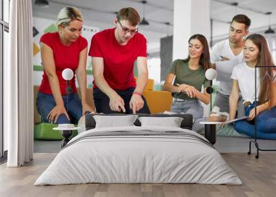 caucasian people practice an exercise of resuscitation during lesson, help injured people, first aid and medicine concept Wall mural