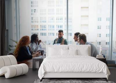 Confident man teaching young friendly happy leaders, coach talking with co-workers in modern office with panoramic window Wall mural