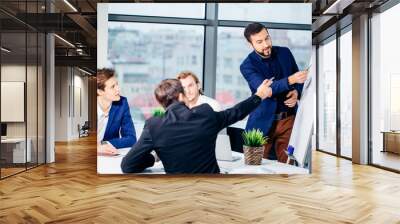 Director of company having business meeting with his staff. showing presentation on flipchart or magnetic desk Wall mural