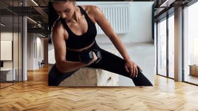 Fit caucasian woman with dumbbells training in gym. Cross fit Wall mural