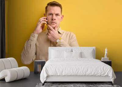 guy sharing ideas with business partner while talking on phone Wall mural