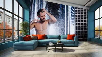 handsome man with strong muscles, perfect body stand under running water taking shower Wall mural