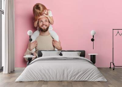 happy handsome daddy looking at his little adorable girl who is sleeping on his shoilders, redt time, free time, spare time. close up portrait, isolated pink background, studio shot Wall mural