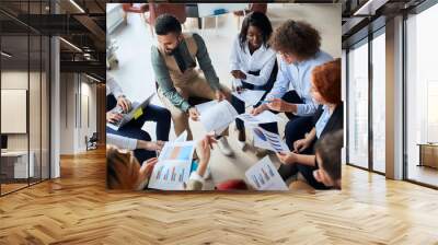 International team of business people use diagrams for better explaining, thinking, building business strategy. People wearing formal wear sit around, together in circle Wall mural