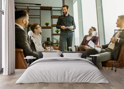 leisure time at work of business crew consisted of young men leaders in elegant suits, happy business partners or colleagues after successful conference, meeting in boardroom Wall mural