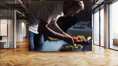 Male cook serve delicious steak on the cutting board at street cafe Wall mural