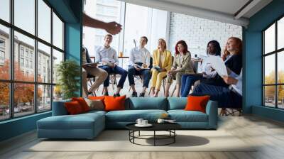 Male mentor executive leader talking during briefing, multi-ethnic workers engaged in corporate training sitting attentively listen Wall mural