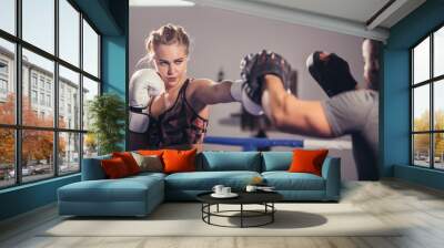 muscular young man and woman boxing together Wall mural