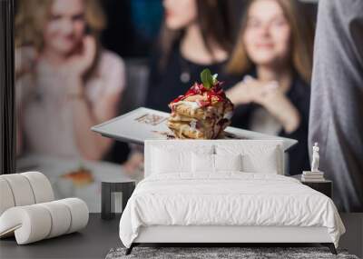 Picture presenting happy group of friends eating donuts outdoors (selective focus) Wall mural