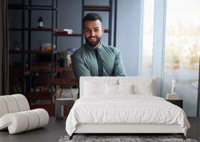 portrait of confident young handsome middle eastern businessman standing in office, looking at camera, successful team leader wearing formal wear, posing for photo at workplace Wall mural