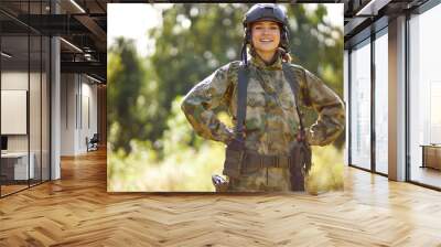 portrait of positive caucasian soldier woman smiling at camera, in nature, posing. war, hunting, military concept Wall mural