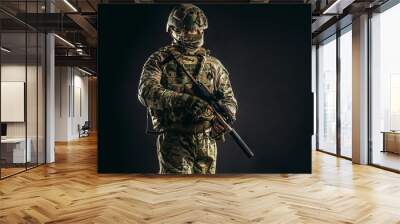 portrait of serious confident brave soldier in army wear, camouflage, isolated over black background. military forces concept Wall mural