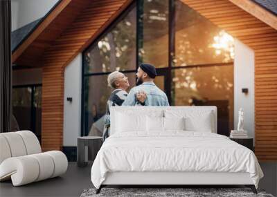 Rear view on lovely couple looking at new countryhouse. Excited man and woman, smile and happy together Wall mural