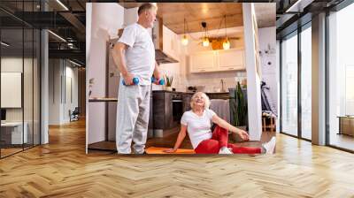 senior couple do exercises at home together, yoga and workout with dumbbells Wall mural