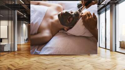 Spa concept. Young woman with nutrient facial mask in beauty salon, close up Wall mural