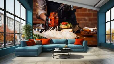 The chef prepares a Burger with beef chop, cheese and vegetables . Wall mural