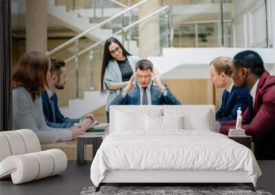 Tired business team at conference in the office Wall mural