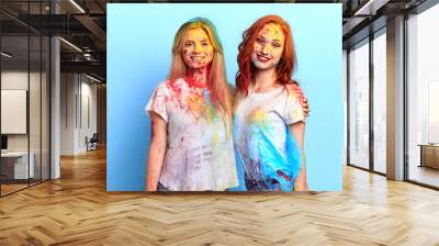 two best friends taking part in the festival. close up portrait, isolated blue background, studio shot, harvest season , religious festival Wall mural