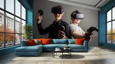 two young man playing game using virtual reality headset Wall mural