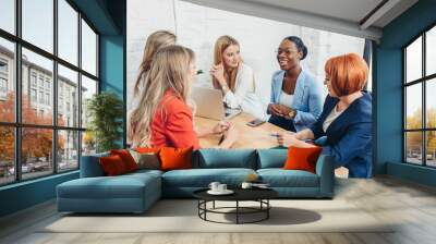 Young mixed race women team up with freelance friends and create a small coworking club that can eventually grow into a small firm. Wall mural