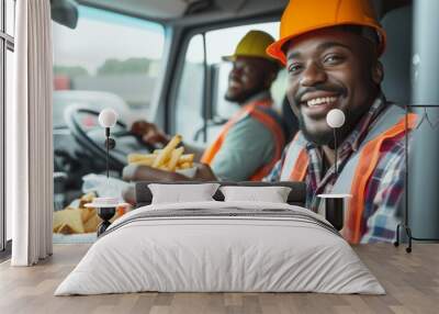 A happy truck driver and coworker eat lunch in the truck cabin Wall mural