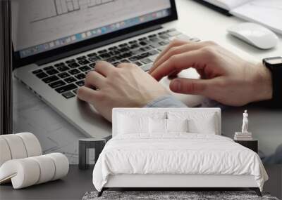 An architect's hands typing on a laptop keyboard, with architectural software and a digital blueprint displayed on the screen Wall mural