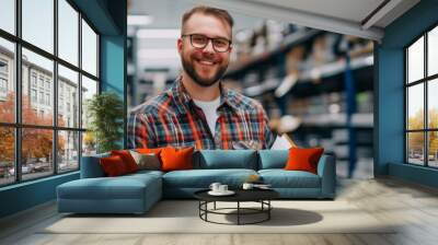 Cheerful salesman in an auto parts store, with a notebook in hand Wall mural