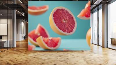 Fresh Pink Grapefruit Slices on Blue Background Wall mural