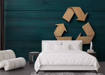 Wooden recycle symbol on dark green wooden background representing sustainability and eco-friendly concept in modern design. Wall mural