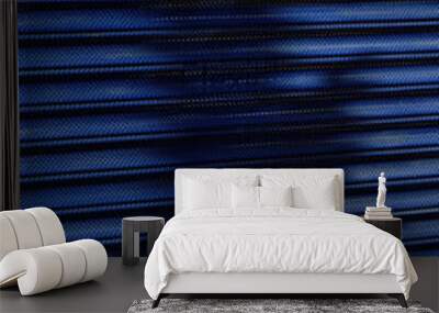 Shadows and lights on blue shop rolling shutter Wall mural