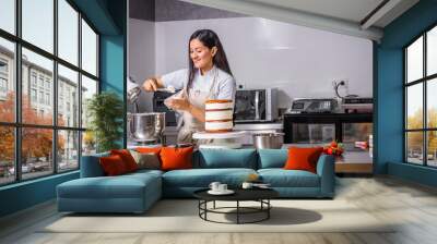 Colombian pastry chef smiling preparing her cake. Happy work Wall mural