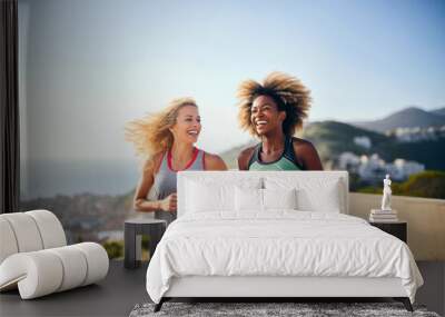 Two women jogging on beach promenade, embracing a fit lifestyle during summer Wall mural