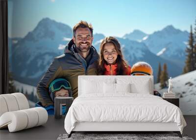 Happy family of four posing at snow capped mountain summit Wall mural