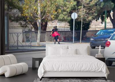 Girl rollerblading in the city, using bike lane in Seville, Spain Wall mural