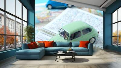 Two miniature classic cars driving through a road map. Space for text. Concept of travel and tourism by car. Wall mural