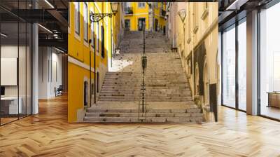 Typical steep street with long stairs and colorful walls of the city of Lisbon, Portugal.  Wall mural