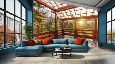 Large Porch of the log cabin at sunset with forest view Wall mural