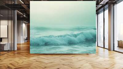 A wave crashing in a misty sea. Wall mural