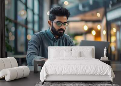 an Indian software engineer working on laptop in modern office, portrait of a man working on laptop  Wall mural