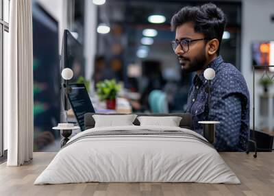 an Indian software engineer working on laptop in modern office, portrait of a man working on laptop  Wall mural